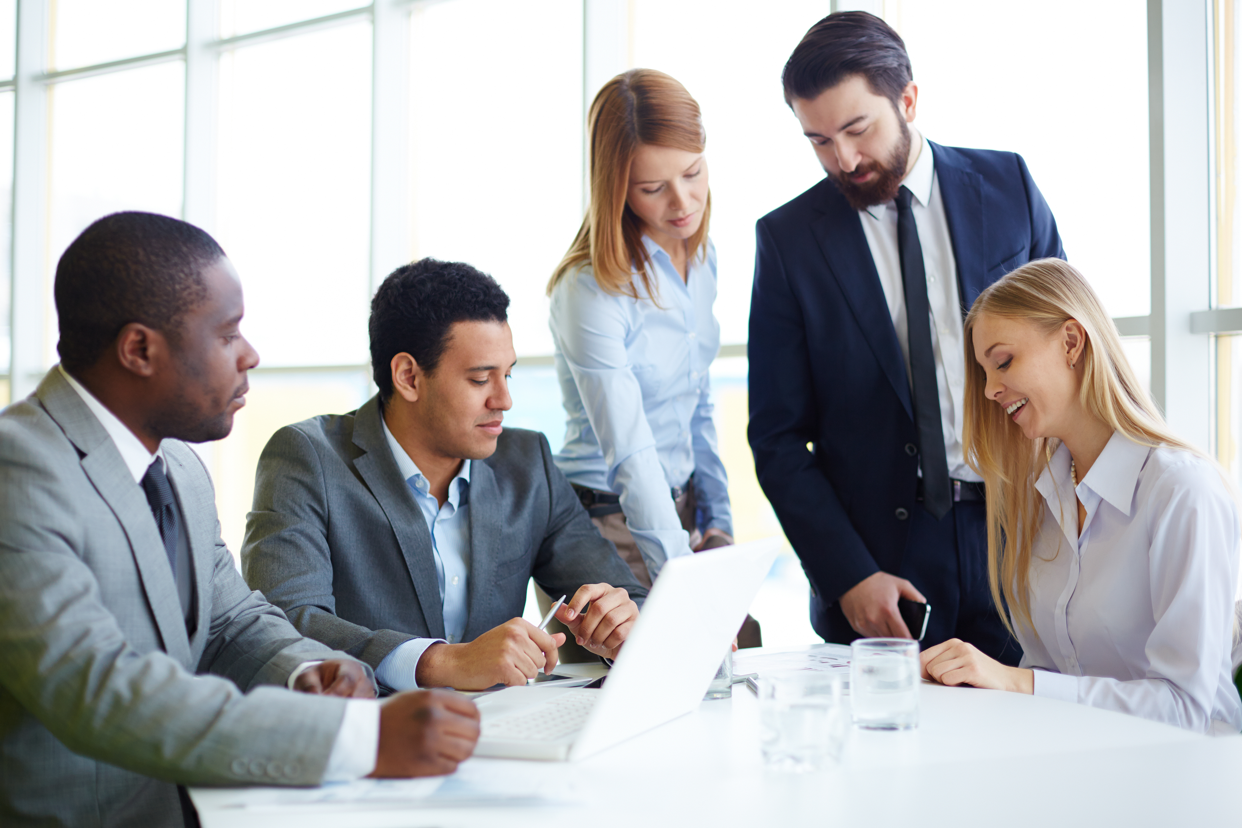 Group of business partners discussing ideas and planning work in