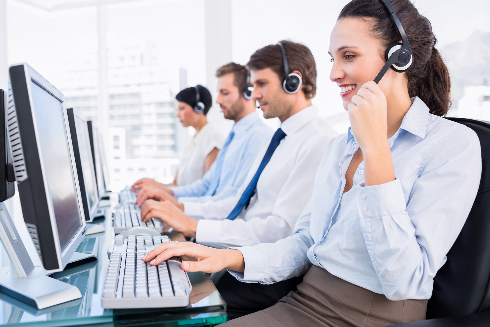 Side view of a group of business colleagues with headsets using