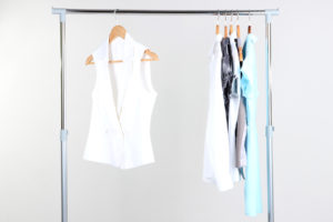 Office female clothes on hangers, on gray background