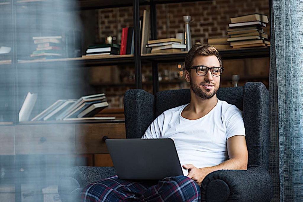 Man working from home in pjs Pivotal HR Solutions Blog