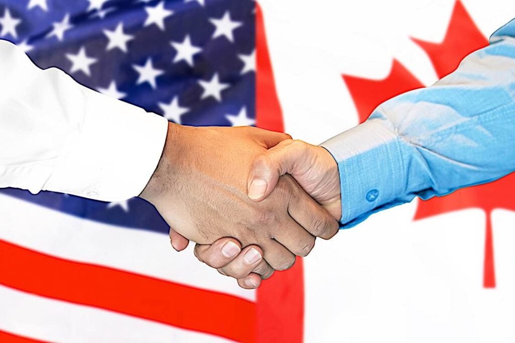 Canada US flag hand shake PEO EOR dreamstime 146598949 Pivotal HR Solutions Blog