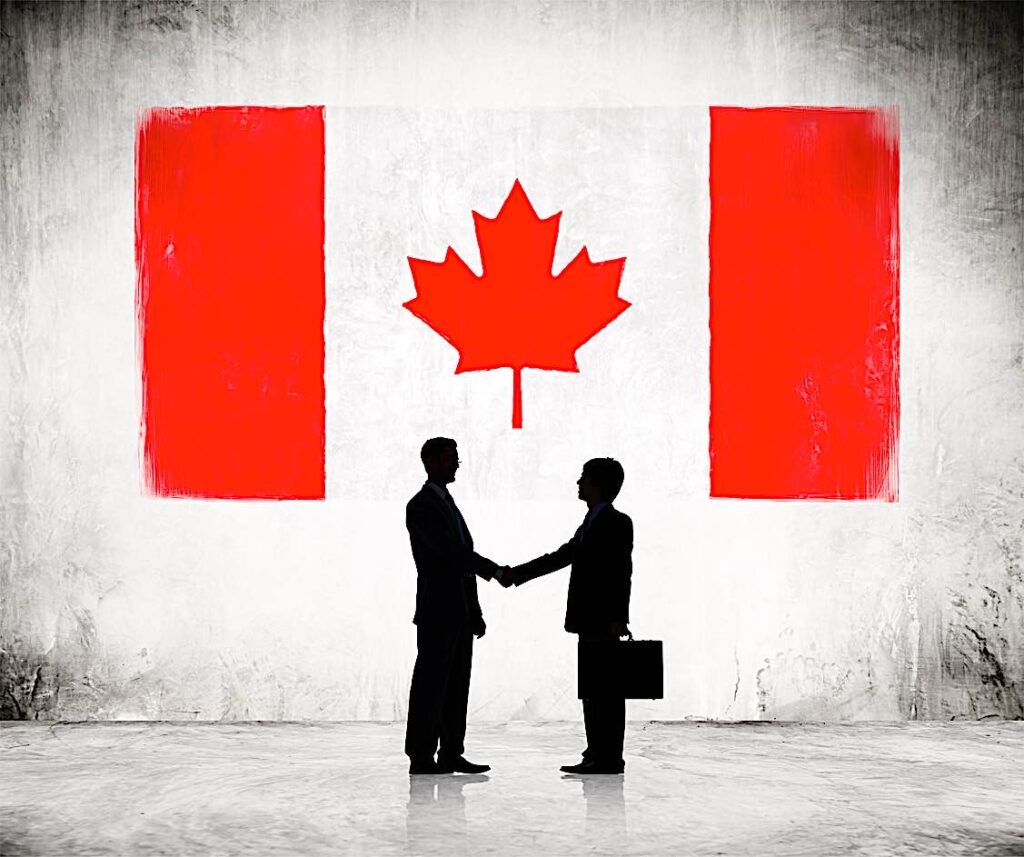 Shakilng hands in front of Canadian Flag PEO EORdreamstime 39551170 Pivotal HR Solutions Blog