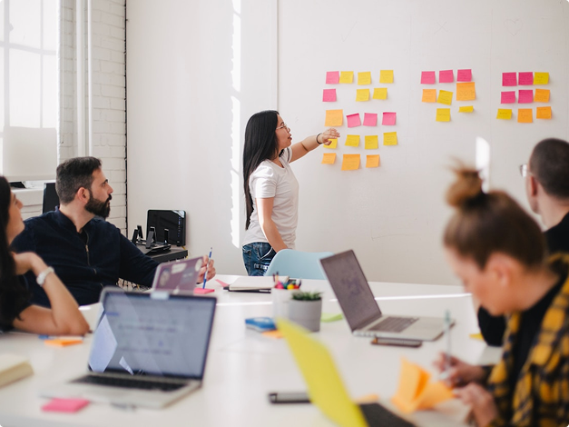Woman placing sticky notes on a wall