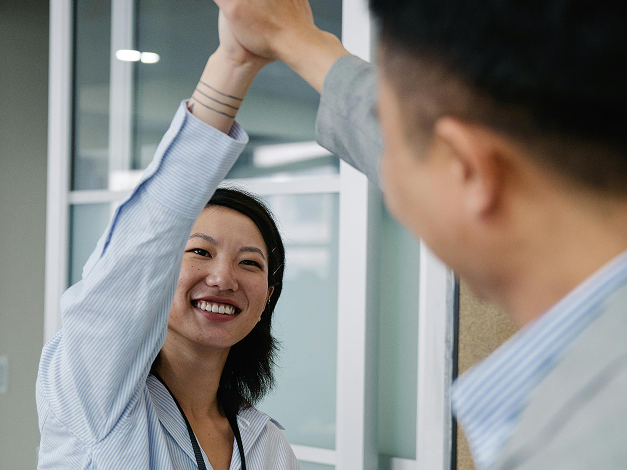 A Woman and Man High Fiving