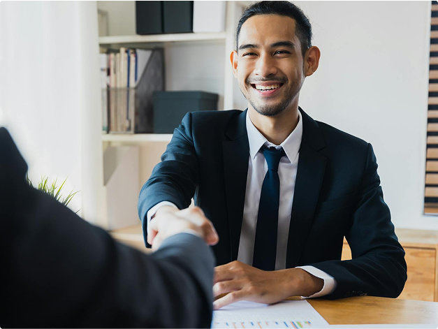 Businessmen shaking hands while smiling