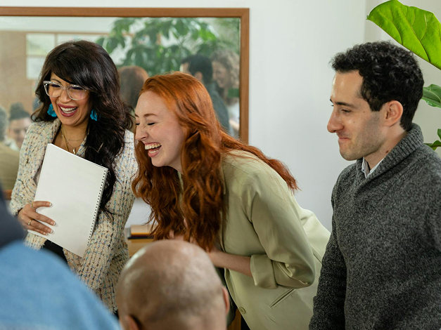 Coworkers laughing in a meeting