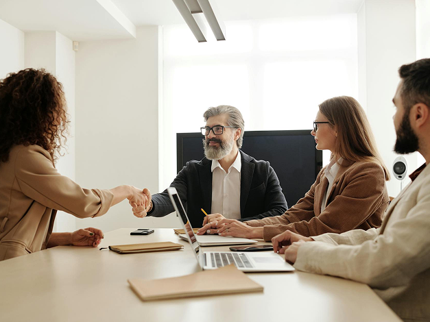 Man and woman shaking hands in business meeting