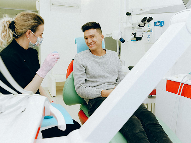 Man in grey shirt having a dentist check-up