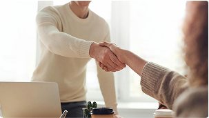 Man in white shirt shaking hands