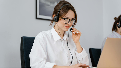 Woman in a White Shirt Holding the Microphone on Her Headset