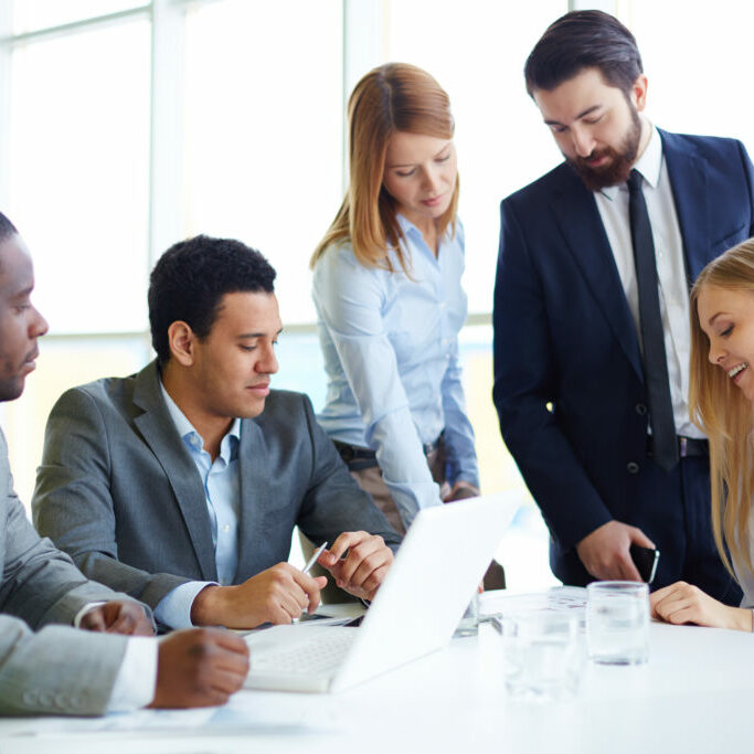 Group of business partners discussing ideas and planning work in office