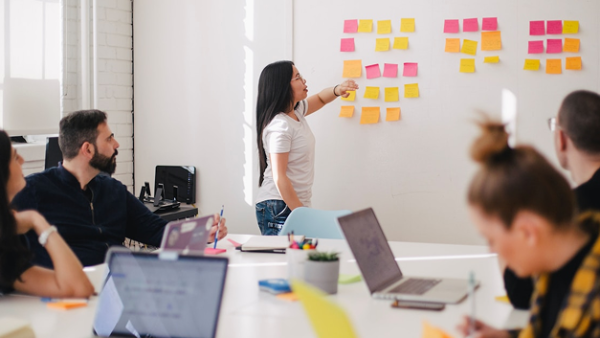 Woman placing sticky notes on a wall
